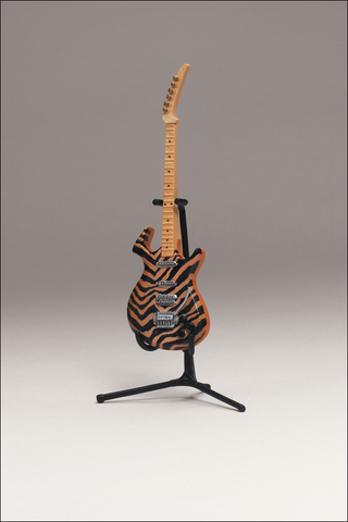 Illustration for article titled McFarlane's Tiny, Plastic Guitar Hero Guitars